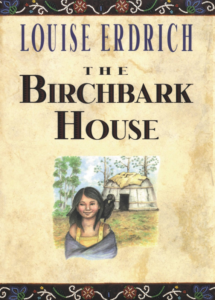 The cover of The Birchbark House has a girl standing outside a home in the woods