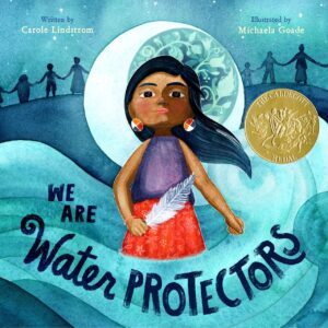 The cover of We Are Water Protectors has a girl holding a feather in a wave