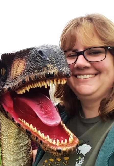 Erin Kant Barnard with a velociraptor sculpture