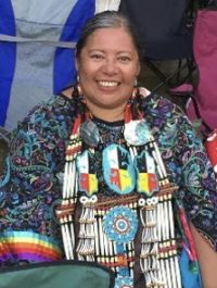Headshot portrait of Esie Leoso Corbine in tribal regalia